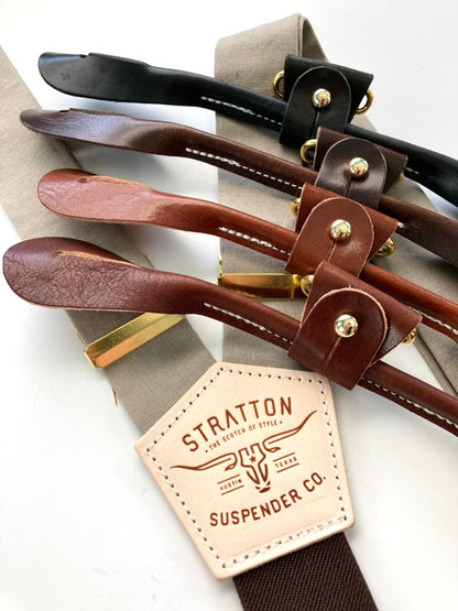 Neutral linen suspenders in mushroom with four premium leather attachment options, shown with gold adjusters.
