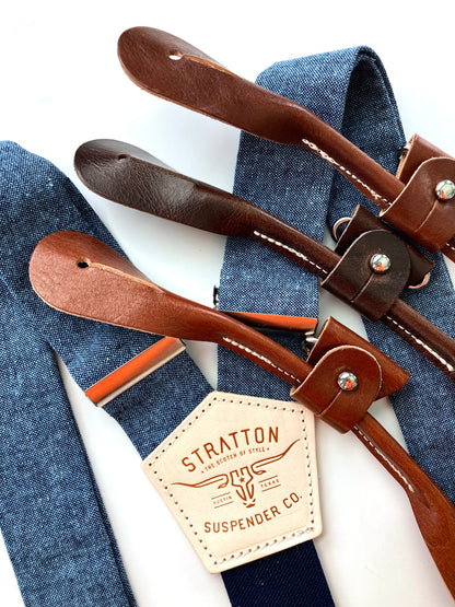Stratton Suspender Co. nautical blue linen suspenders with tan, cognac, and chocolate full-grain leather button-on ends, ideal for groomsmen, rustic weddings, or vintage menswear.