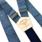 Close-up of Stratton Suspender Co. nautical blue linen suspenders with navy back strap and full-grain leather patch, ideal for rustic wedding or vintage menswear.