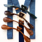 Stratton Suspender Co. Nautical Blue linen suspenders with navy elastic back and four full-grain leather button-on tab color options—black, dark brown, chestnut, and saddle tan—displayed on a white background.
