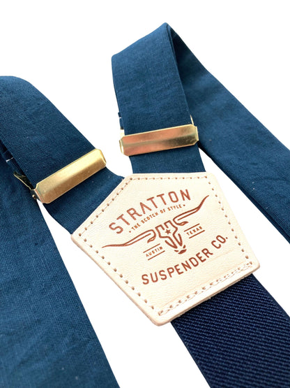 Elegant navy suspenders with deep blue elastic back strap and polished gold hardware, designed for refined wedding or event styling.