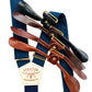 Navy and midnight blue suspenders with gold hardware, shown with four leather button tab options in black, chocolate, cognac, and tan.