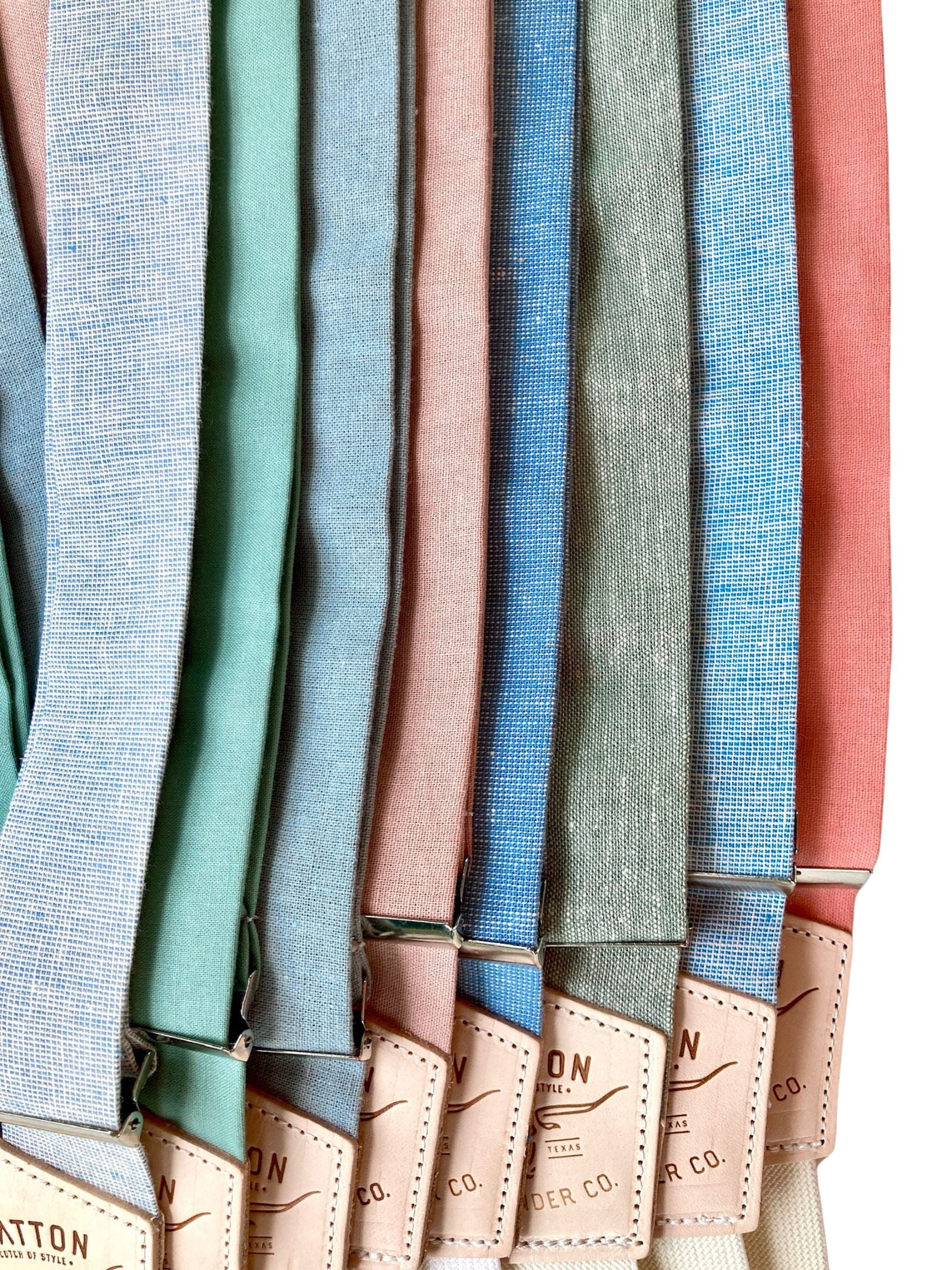Close-up of pastel linen suspenders from Stratton Suspender Co. in powder blue, sage, dusty rose, French blue, sea glass, and coral—handmade for spring and summer weddings, groomsmen outfits, and formal menswear styling.