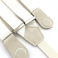 Close-up of pearl white linen suspenders with ivory magnetic leather clasps and silver hardware