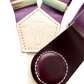 Close-up of plum linen women’s suspenders with special-edition wine leather magnetic clasp, handmade in Texas.