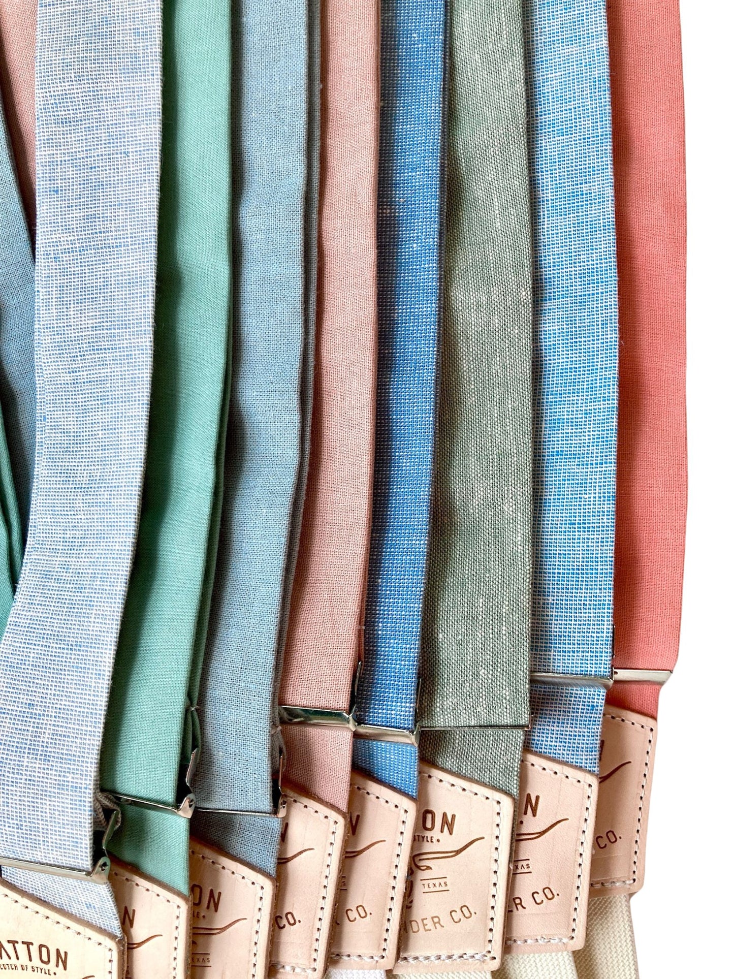 A collection of elegant linen wedding suspenders in Powder Blue, Sage, Dusty Blue, Dusty Pink, French Blue, Sea Glass, Cornflower Blue, and Salmon. Designed for spring and summer weddings, groomsmen, and formal events. Handcrafted with premium leather accents for a timeless vintage look.