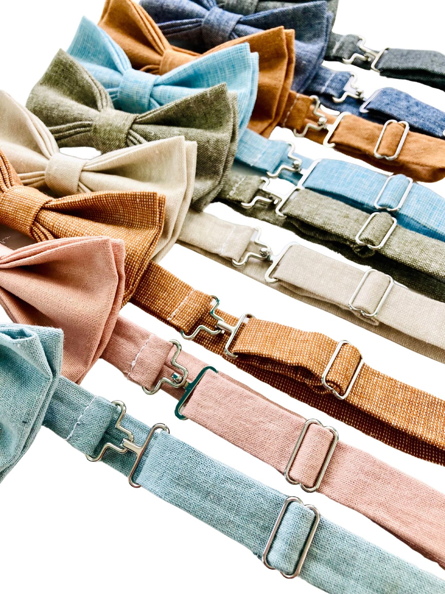 Close-up of adjustable pre-tied linen bow ties in assorted earth and pastel tones, handmade for weddings, groomsmen gifts, and rustic formalwear by Stratton Suspender Co.