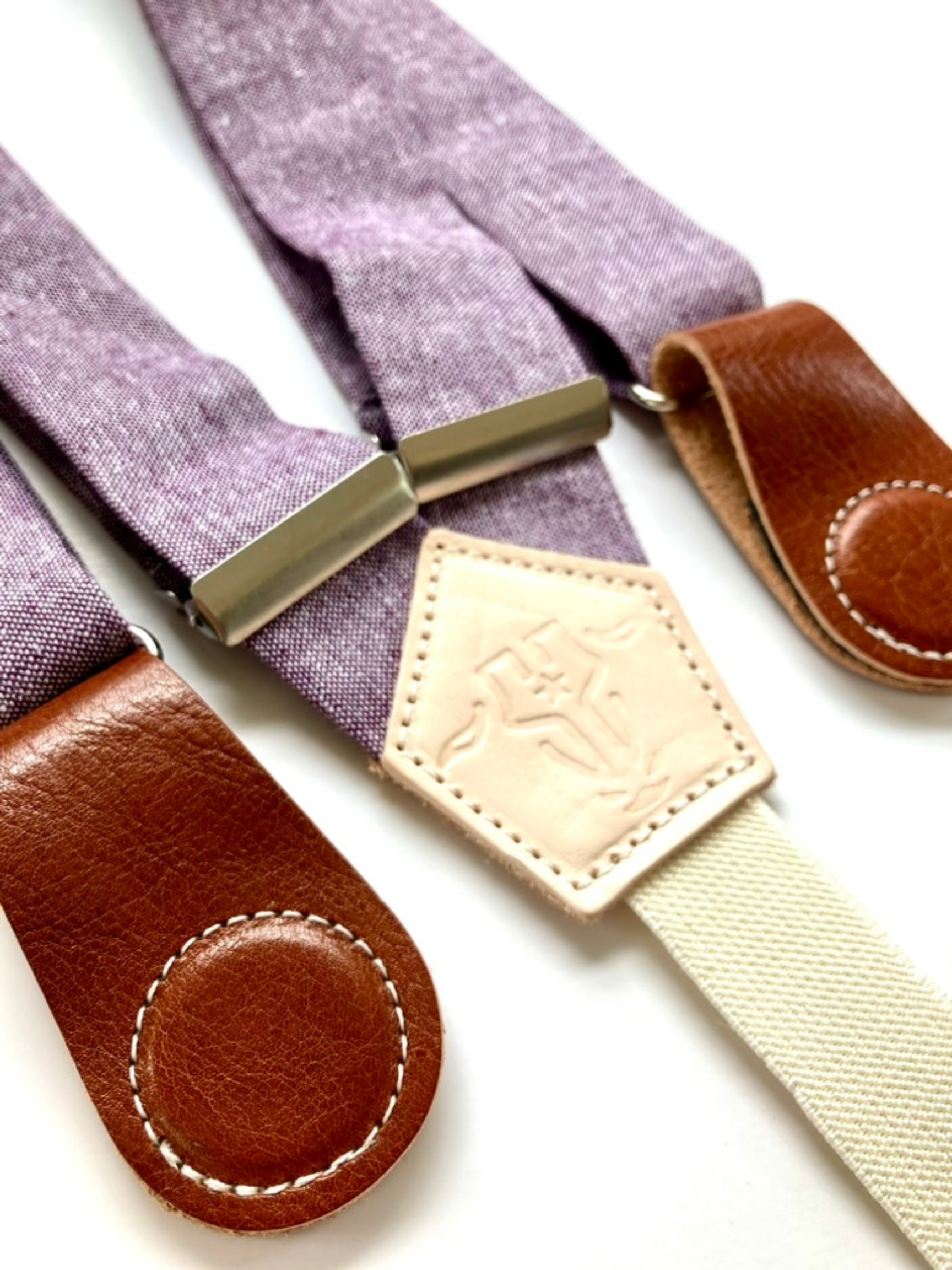 Purple women’s suspenders made from French linen with tan leather magnetic clasps, perfect for boho, western, and rustic outfit styling.