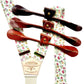 Close-up of rose garden floral linen suspenders with brown leather button-on straps, handmade in Texas by Stratton Suspender Co.—vintage wedding braces for groom and groomsmen, rustic formalwear accessory.