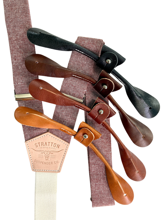 Rust maroon linen button-on suspenders handmade in Texas by Stratton Suspender Co., shown with tan, cognac, chocolate, and black leather tabs for heritage menswear, rustic weddings, and groomsmen formalwear.