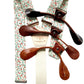 Full view of rustic orange and green floral suspenders with cream elastic back and brown leather button-on loops, handcrafted by Stratton Suspender Co. for rustic weddings and vintage formalwear.