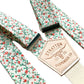 Rustic orange and green floral wedding suspenders with vintage calico pattern and cream elastic back, handmade by Stratton Suspender Co. for groom and groomsmen button-on formalwear.