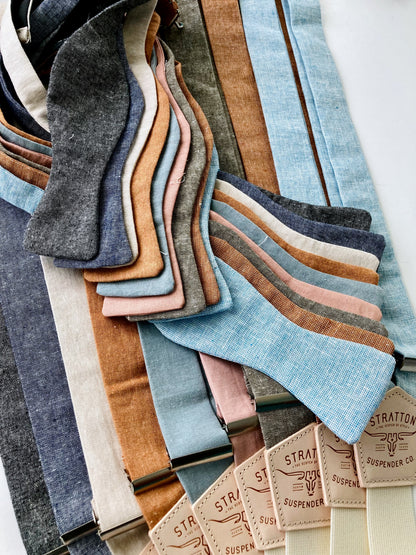 Rustic linen self-tie bow ties with matching suspenders in earthy tones, perfect for groomsmen, weddings, and vintage-inspired formal menswear.