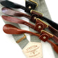 Sage green suspenders with ivory back strap and full-grain leather button-on ends in black, chocolate, cognac, and tan, handmade for groomsmen and vintage wedding style.