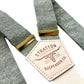 Sage green linen wedding suspenders with ivory elastic back strap and gold hardware, vintage button-on design for groomsmen and classic menswear.