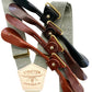 Sage green suspenders with ivory back strap and leather button-on attachment options in black, chocolate, cognac, and tan, perfect for groomsmen and vintage wedding attire.