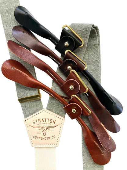 Sage green suspenders with ivory back strap and leather button-on attachment options in black, chocolate, cognac, and tan, perfect for groomsmen and vintage wedding attire.