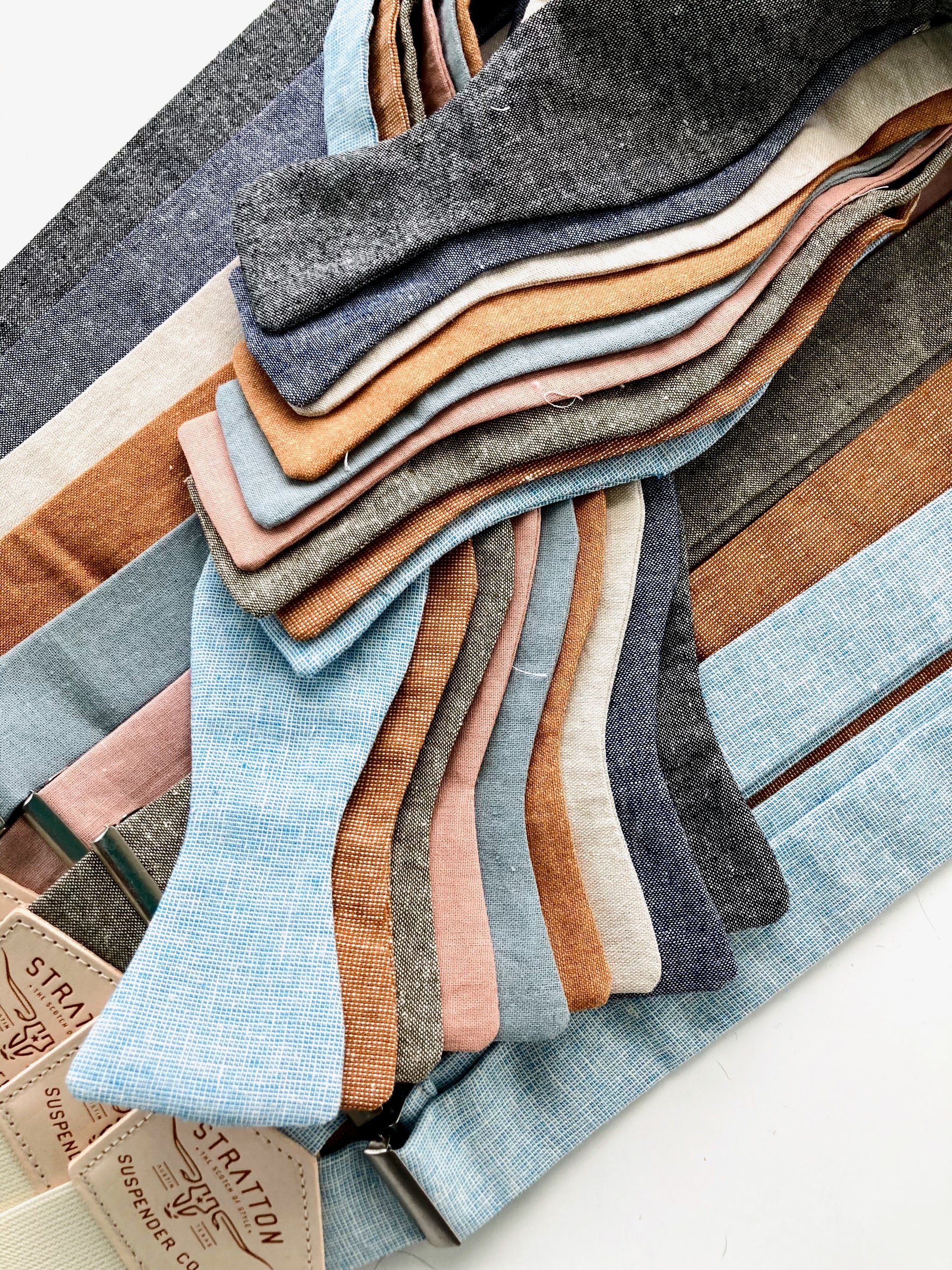 Self-tie linen bow ties with coordinating suspenders in earthy wedding tones, perfect for groomsmen and men's rustic formalwear.