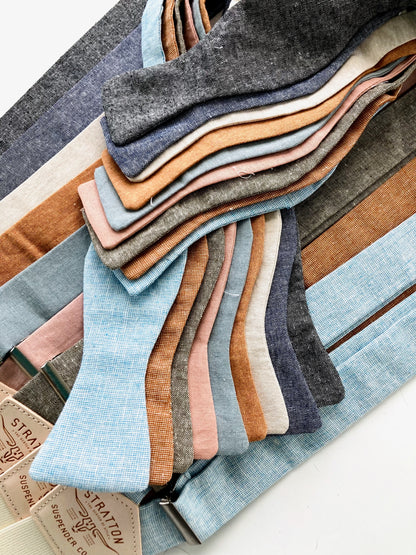 Self-tie linen bow ties with coordinating suspenders in earthy wedding tones, perfect for groomsmen and men's rustic formalwear.