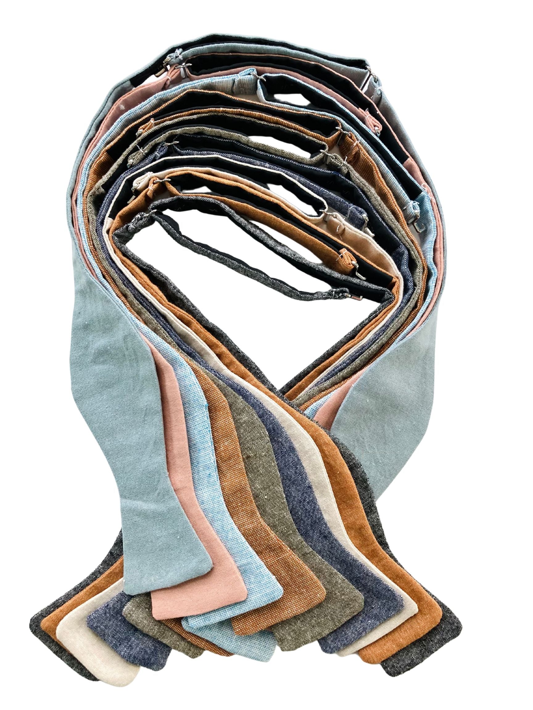 Wedding groomsmen collection of self-tie bow ties in dusty blue, dusty rose, burnt orange, olive, beige, navy, and black linen — perfect for rustic or formal weddings.