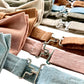 Close-up of silver polished brass clasps on handmade linen pre-tied bow ties in popular wedding colors, including powder blue, dusty rose, roasted pecan, and beige—ideal for groomsmen and formal wedding party attire.