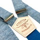 Sky blue linen suspenders with deep blue back strap and silver adjusters, featuring a tan leather patch embossed with Stratton Suspender Co. branding — ideal for groomsmen, vintage weddings, and formal menswear.