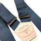 Close-up of slate blue linen button-on suspenders with vintage leather patch — handmade in USA, perfect for groomsmen or rustic weddings