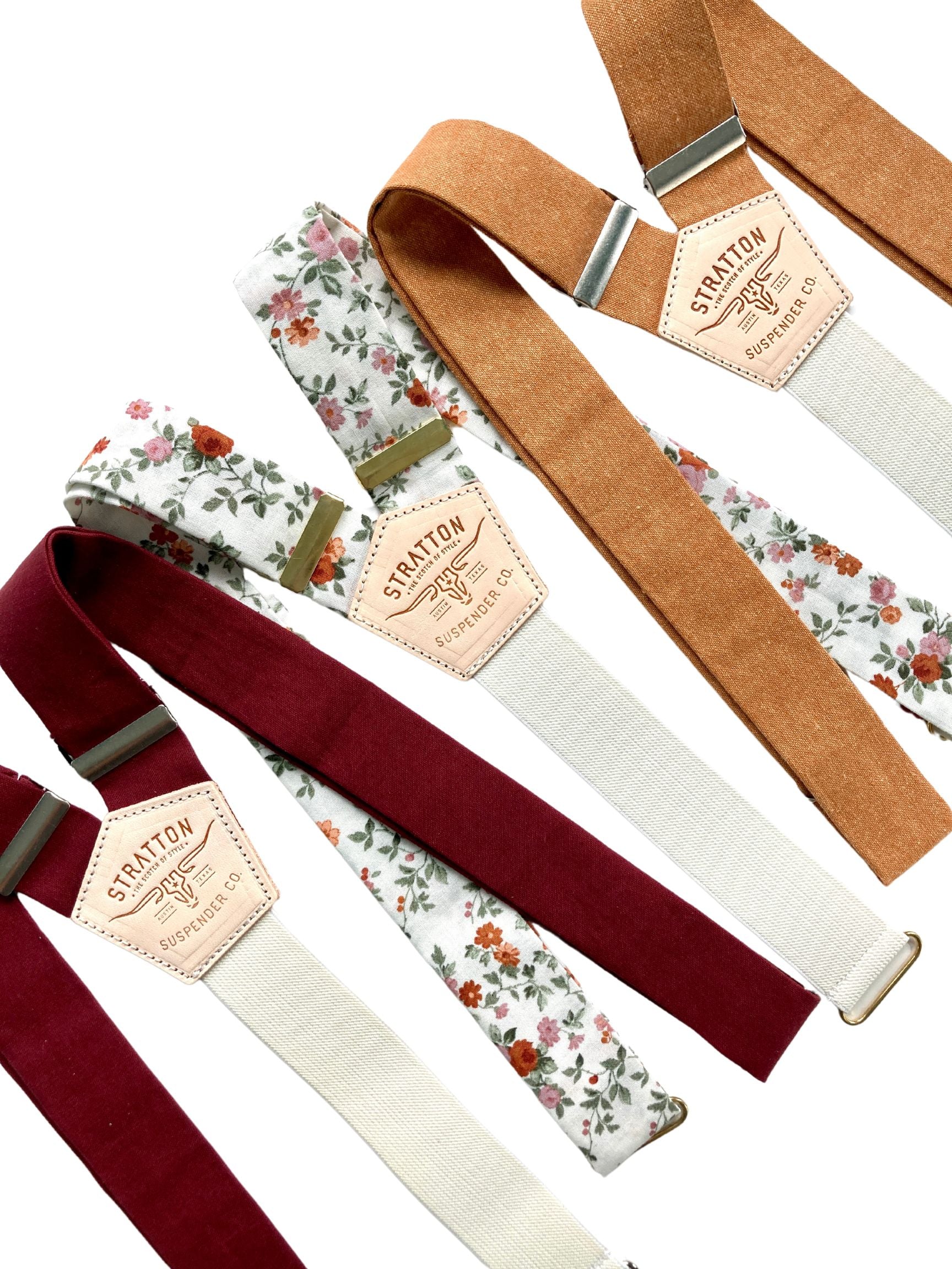 Fall wedding suspenders collection featuring burgundy linen, burnt orange linen, and floral print braces; handmade in Texas for groomsmen and rustic weddings.