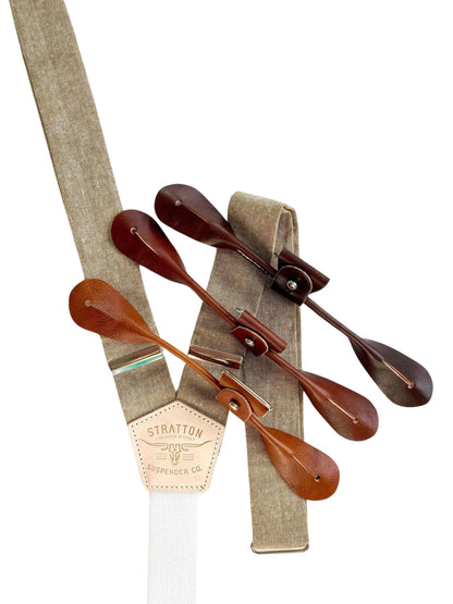 Close-up of Stratton Suspender Co.’s Taupe Linen Button-On Suspenders, handmade in Texas with warm leather tabs and rustic neutral tones—ideal for groomsmen or timeless menswear.