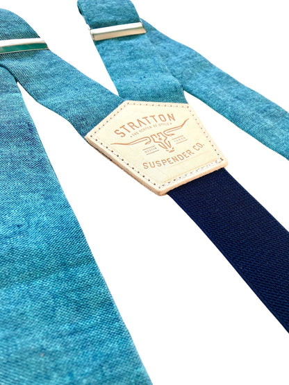 Close-up of turquoise blue Malibu linen wedding suspenders with a navy back strap and premium leather detailing. Handmade in USA – perfect for groomsmen, beach weddings, and vintage-inspired menswear.