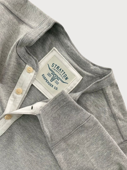 Close-up of Vintage 1940s Heather Gray Heavyweight Henley by Stratton Suspender Co., highlighting the ribbed sleeve cuff, three-button placket with contrasting white trim, and embroidered brand label. Made in the USA for durability and classic heritage workwear style.