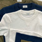 Stack of vintage 1940s heavyweight t-shirts in white, navy, and olive by Stratton Suspender Co. Crafted for durability and classic American style, these heritage-inspired tees feature a rugged slub texture, reinforced stitching, and a timeless fit perfect for workwear or casual menswear.