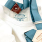 Vintage 1940s waffle knit thermal shirt in white, paired with Muted Teal suspenders featuring brown leather button attachments. This heavyweight long sleeve thermal is inspired by classic American workwear, offering warmth, durability, and timeless heritage style. Ethically made in the USA by Stratton Suspender Co.