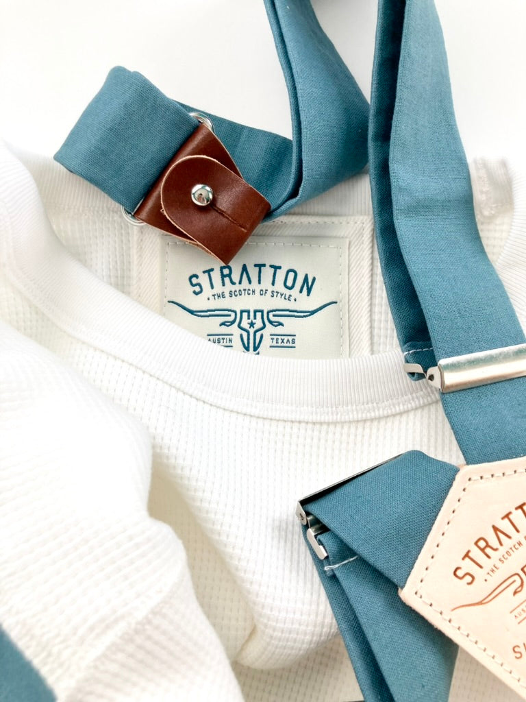 Vintage 1940s waffle knit thermal shirt in white, paired with Muted Teal suspenders featuring brown leather button attachments. This heavyweight long sleeve thermal is inspired by classic American workwear, offering warmth, durability, and timeless heritage style. Ethically made in the USA by Stratton Suspender Co.