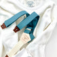 Vintage 1940s heavyweight waffle knit thermal shirt in vintage white, paired with Muted Teal suspenders with brown leather button attachments. Ethically made in the USA, this classic workwear-inspired layering piece offers warmth, durability, and heritage style. Stratton Suspender Co.