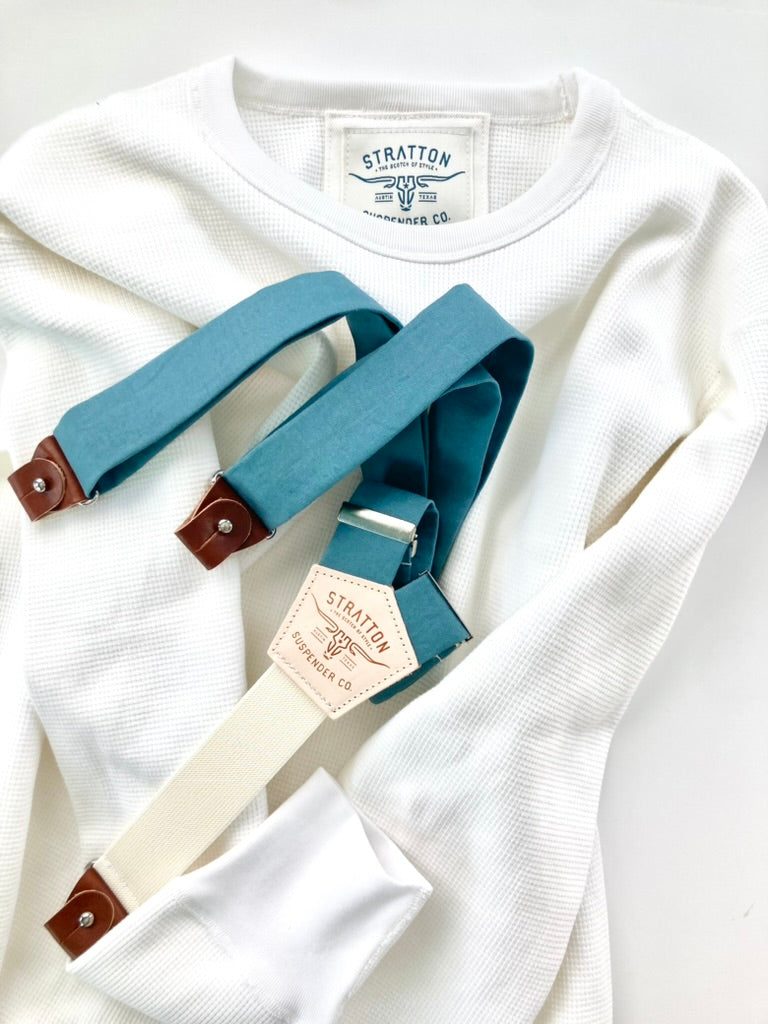 Vintage 1940s heavyweight waffle knit thermal shirt in vintage white, paired with Muted Teal suspenders with brown leather button attachments. Ethically made in the USA, this classic workwear-inspired layering piece offers warmth, durability, and heritage style. Stratton Suspender Co.