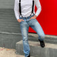 Man wearing a vintage-inspired white waffle knit thermal shirt paired with black suspenders, light-wash vintage Levi’s jeans, and black Dr. Martens boots. Ethically made in the USA, this heavyweight thermal is designed for warmth, durability, and classic American workwear style. Stratton Suspender Co.