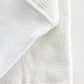 Close-up of the heavyweight white waffle knit thermal shirt’s cuff and textured fabric. Features reinforced ribbed cuffs and classic waffle-knit construction for durability and warmth. Ethically made in the USA by Stratton Suspender Co.
