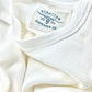Close-up of a vintage-inspired white waffle knit thermal shirt, showcasing its textured fabric, ribbed collar, and the Stratton Suspender Co. label. Ethically made in the USA, this heavyweight thermal is designed for durability, warmth, and timeless American workwear style.