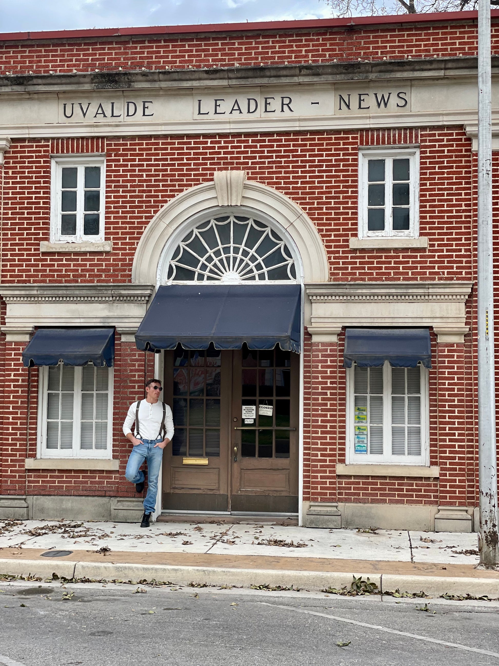 Heritage American Style with Stratton Suspender Co. Vintage Long Sleeve Henley Shirt and Black Button-On Suspenders – Styled with Vintage Levis Denim in Front of Historic Uvalde Leader-News Building – Effortless Austin Texas Street Style