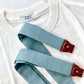 Vintage Pre-War White T-Shirt by Stratton Suspender Co. with Dusty Blue Suspenders featuring brown leather button tabs. Heritage American menswear crafted for timeless style and durability. Ethically made and designed for workwear and classic fashion enthusiasts.