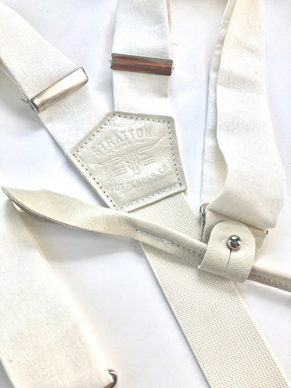 White tuxedo button-on suspenders with polished silver hardware, featuring premium fabric and genuine leather. A refined accessory for weddings, groomsmen, and classic vintage menswear.