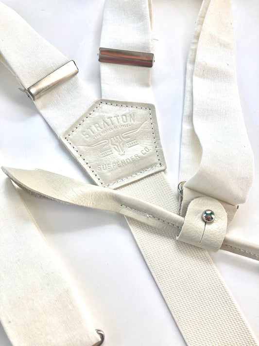White tuxedo button-on suspenders with polished silver hardware, featuring premium fabric and genuine leather. A refined accessory for weddings, groomsmen, and classic vintage menswear.