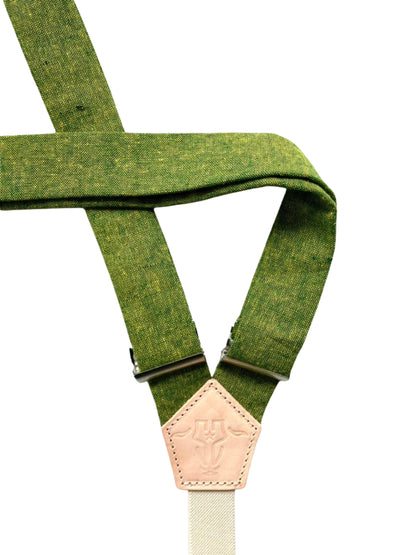 Back view of chartreuse green linen women’s suspenders with natural leather logo patch and cream elastic strap.