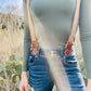 Women’s suspenders styled with jeans and long sleeve top for casual fall outfit