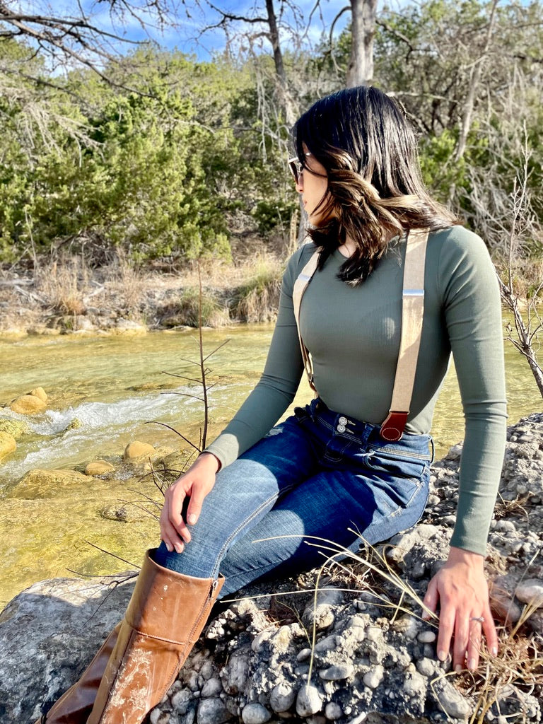 Women’s suspenders with magnetic clasps, rustic outdoor fall fashion styled with denim and leather boots.