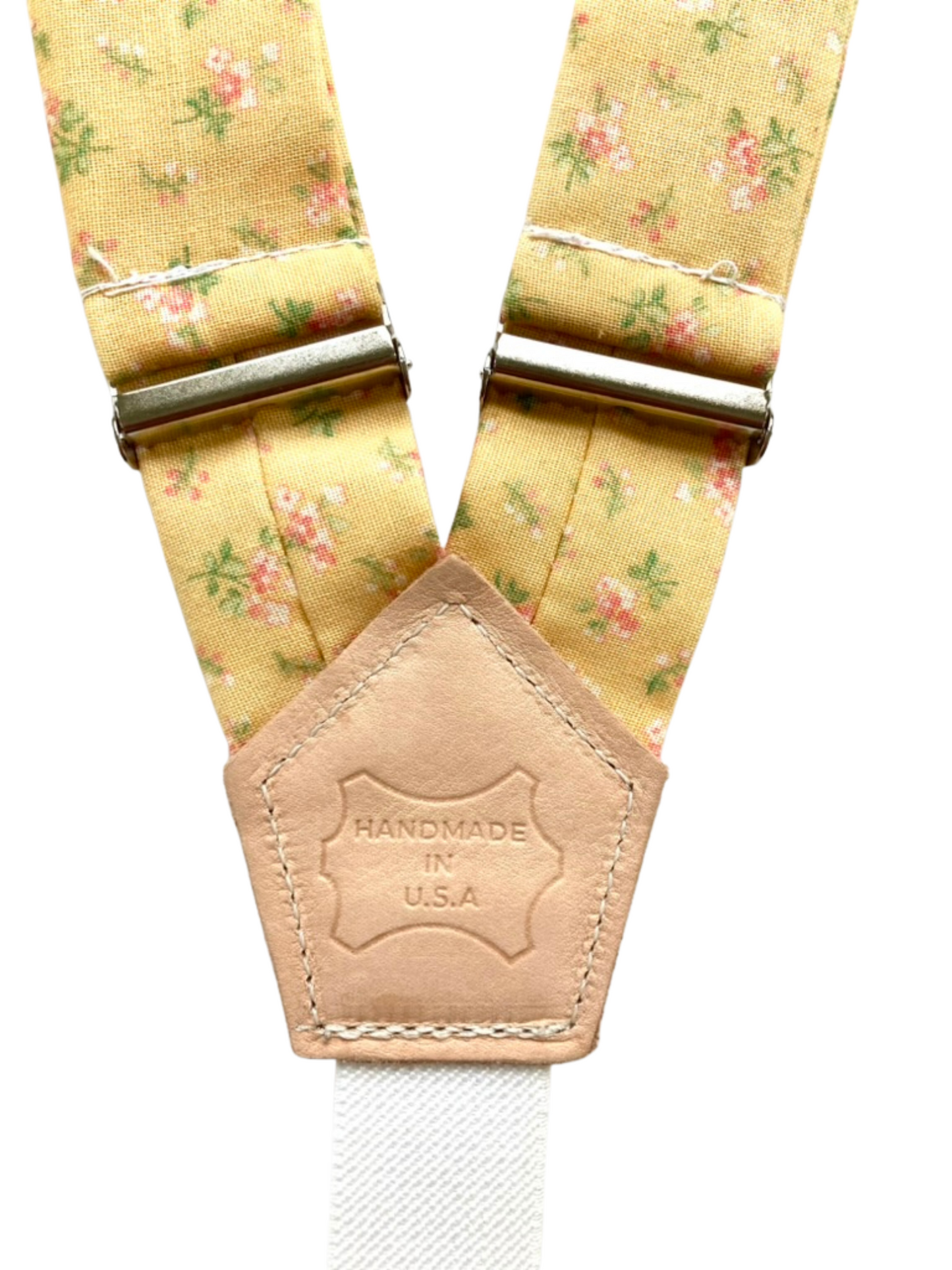 Back patch detail of yellow floral women’s suspenders with polished hardware, handmade in the USA.