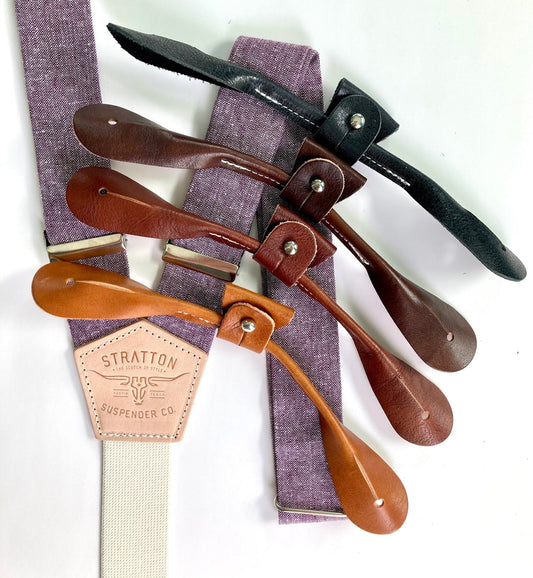 Purple Linen Stratton Suspender Co. Set with one button on attachment in the following colors from top to bottom: Black, Chocolate (dark brown), Cognac (reddish brown), Tan (light brown)