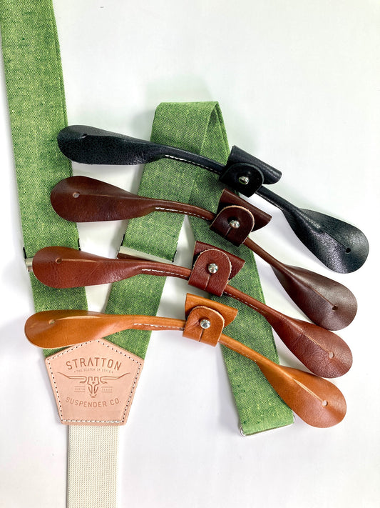 Spruce bright green Linen Stratton Suspender Co. Set with one button on attachment in the following colors from top to bottom: Black, Chocolate (dark brown), Cognac (reddish brown), Tan (light brown)