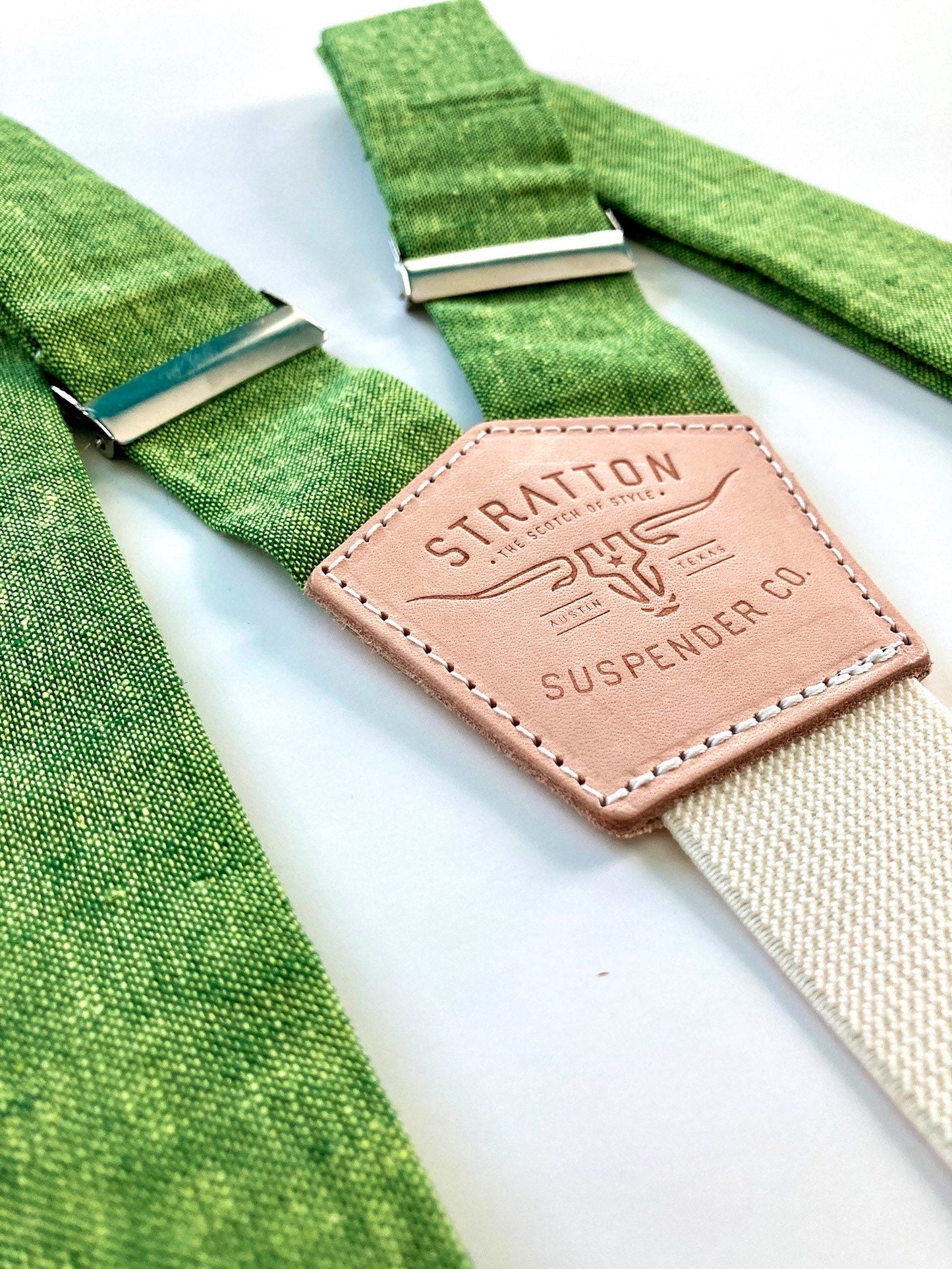 Stratton Suspender Co. features the Spruce bright green linen suspenders on veg tan shoulder leather with cream colored elastic back strap for the Fall 2022 suspenders collection 